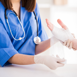 Nurse administering injections and wound dressing at home